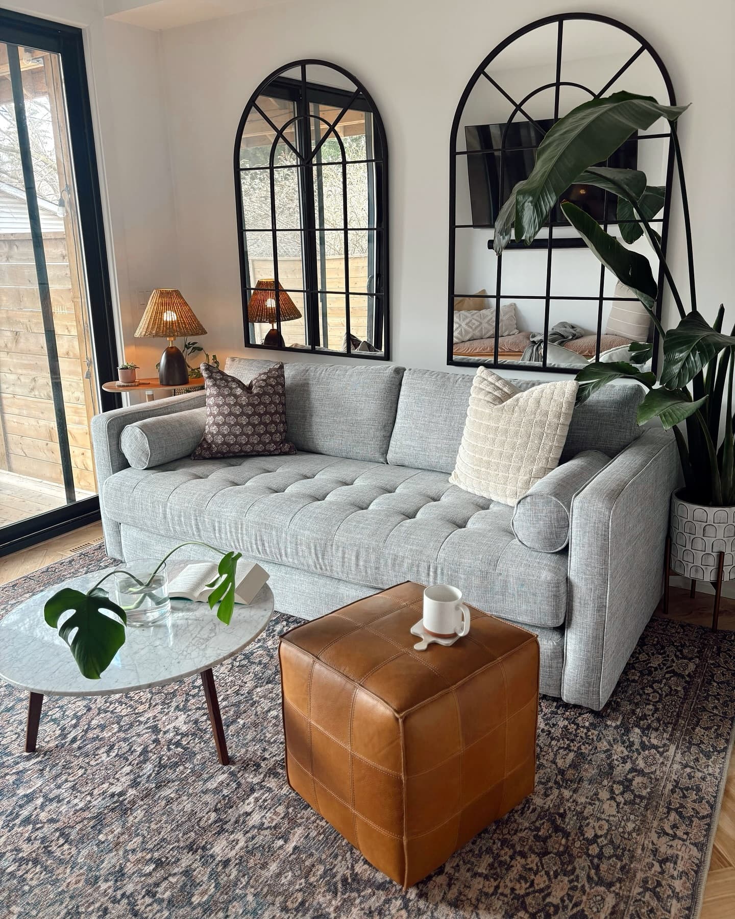 Article Sven fabric sofa in stone gray styled with a vintage rug and modern coffee table.